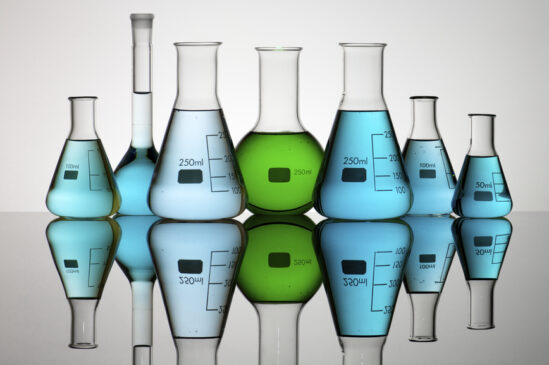 group of laboratory flasks containing liquid color